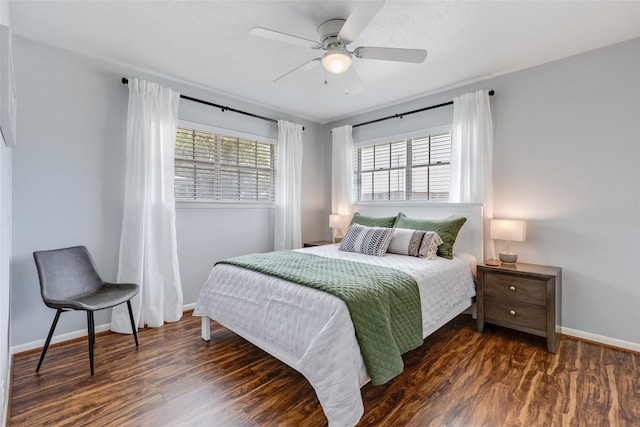 bedroom with ceiling fan and dark hardwood / wood-style flooring