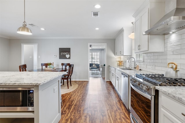 kitchen featuring wall chimney range hood, sink, dark hardwood / wood-style floors, white cabinetry, and stainless steel appliances