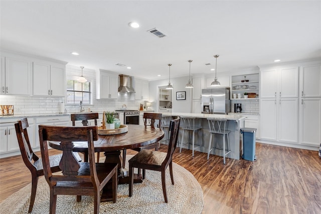 dining space with hardwood / wood-style flooring and sink