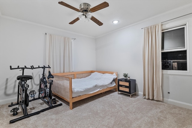 carpeted bedroom with ceiling fan and crown molding