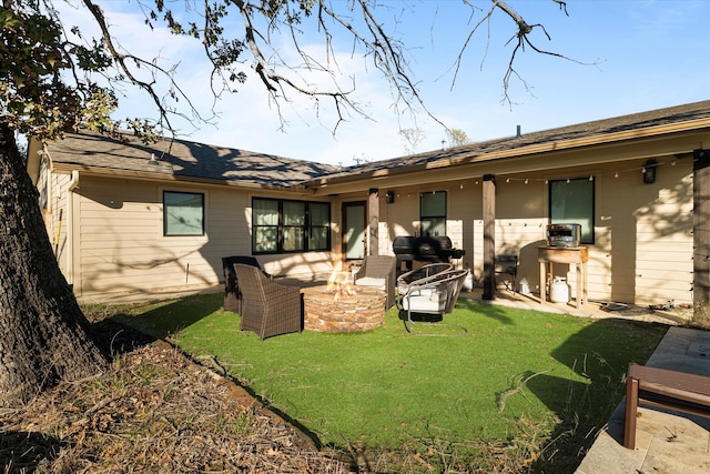 back of property featuring a patio, an outdoor living space with a fire pit, and a lawn