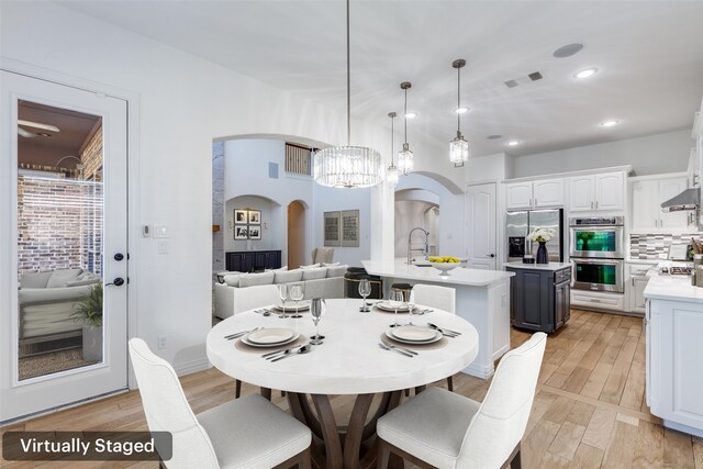 dining area featuring a chandelier and light hardwood / wood-style flooring