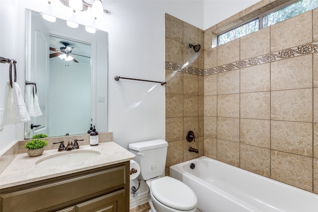 full bathroom featuring vanity, ceiling fan, toilet, and tiled shower / bath