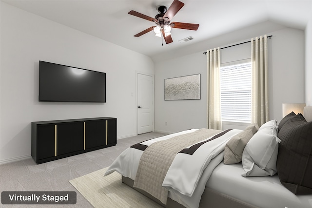 carpeted bedroom featuring ceiling fan and vaulted ceiling