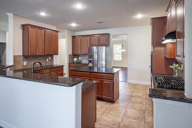 kitchen featuring light tile patterned floors, dark stone countertops, backsplash, stainless steel fridge with ice dispenser, and kitchen peninsula