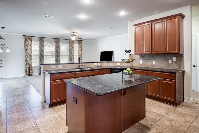 kitchen with pendant lighting, sink, backsplash, ornamental molding, and kitchen peninsula