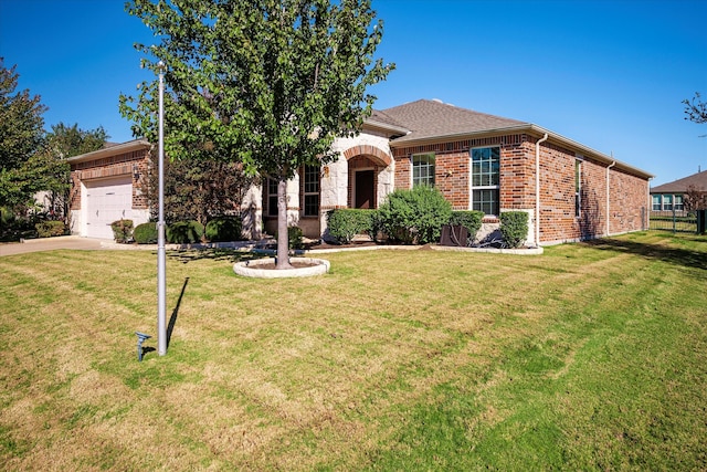 view of front of house with a garage and a front lawn