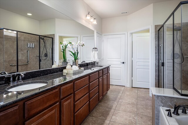 bathroom with vanity, tile patterned flooring, and shower with separate bathtub