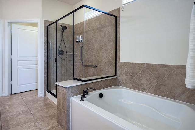 bathroom featuring tile patterned flooring and separate shower and tub