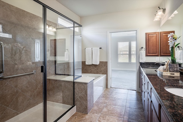 bathroom featuring tile patterned floors, vanity, and shower with separate bathtub