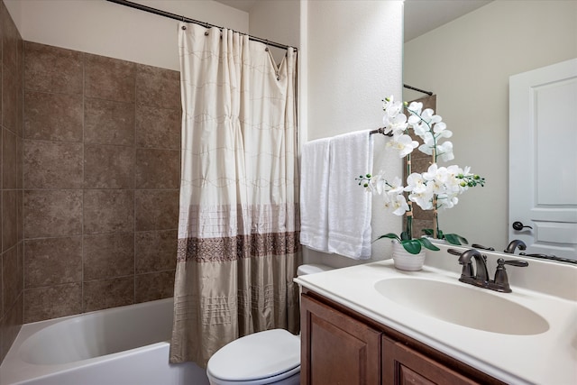 full bathroom with vanity, shower / tub combo with curtain, and toilet