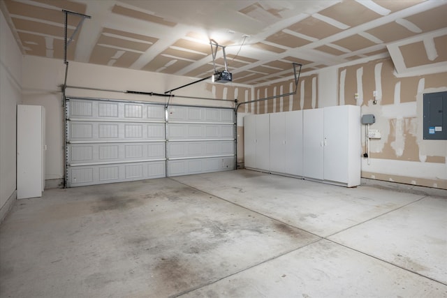 garage featuring a garage door opener and electric panel