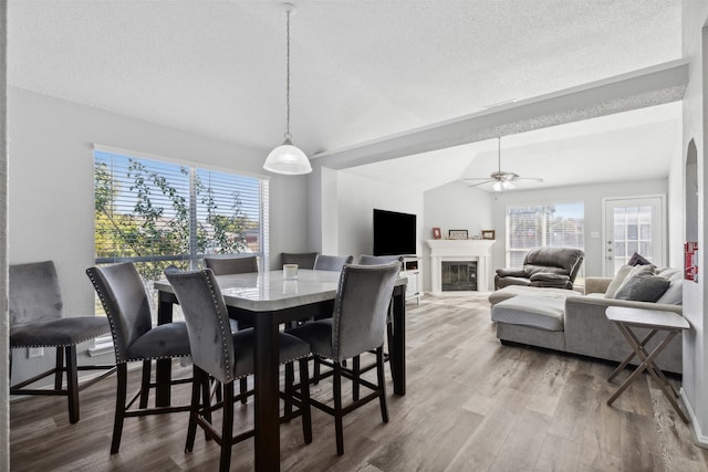 dining room featuring ceiling fan, vaulted ceiling, and hardwood / wood-style flooring