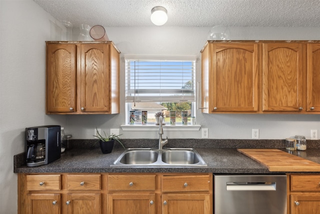 kitchen with dishwasher, a textured ceiling, and sink