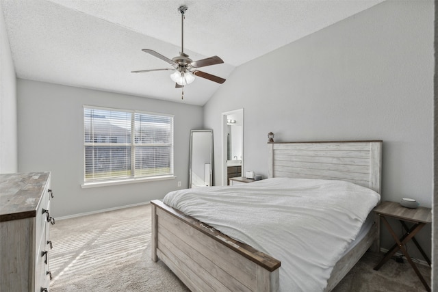 bedroom with ensuite bath, ceiling fan, light colored carpet, a textured ceiling, and lofted ceiling