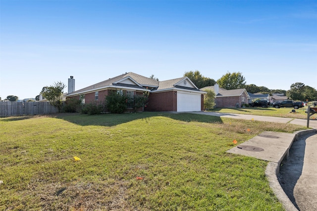 ranch-style house featuring a front yard and a garage