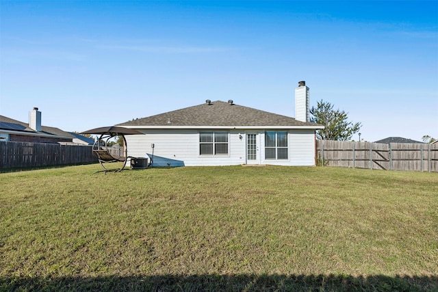 back of house featuring a lawn