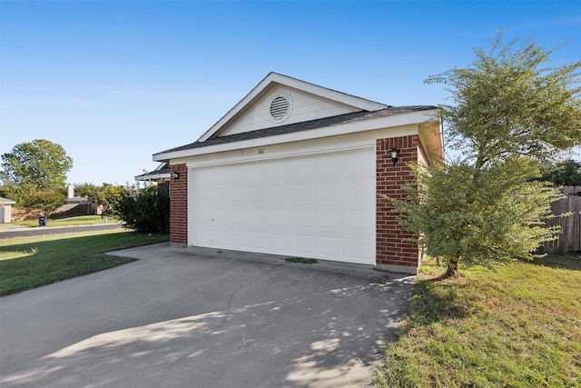 garage featuring a lawn