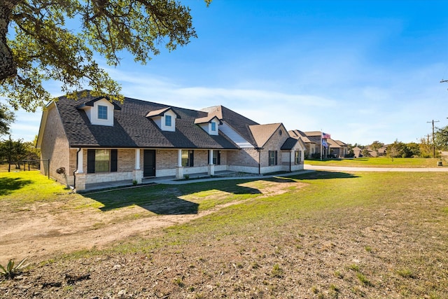 cape cod-style house featuring a front lawn