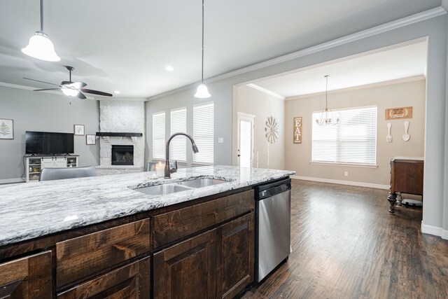 kitchen with light stone countertops, dark wood-type flooring, dark brown cabinets, appliances with stainless steel finishes, and ornamental molding