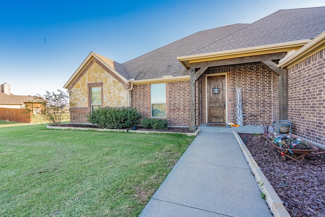 entrance to property featuring a lawn