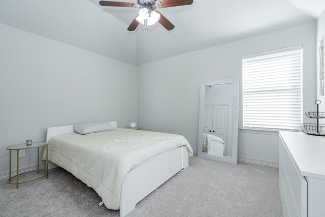 bedroom featuring ceiling fan, light colored carpet, and lofted ceiling