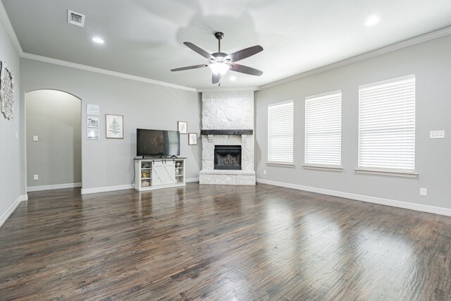 unfurnished living room featuring dark wood-type flooring and ornamental molding