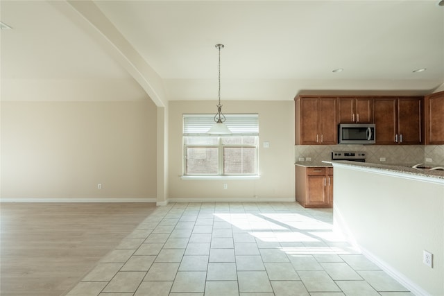 kitchen with beam ceiling, pendant lighting, electric stove, decorative backsplash, and light tile patterned flooring