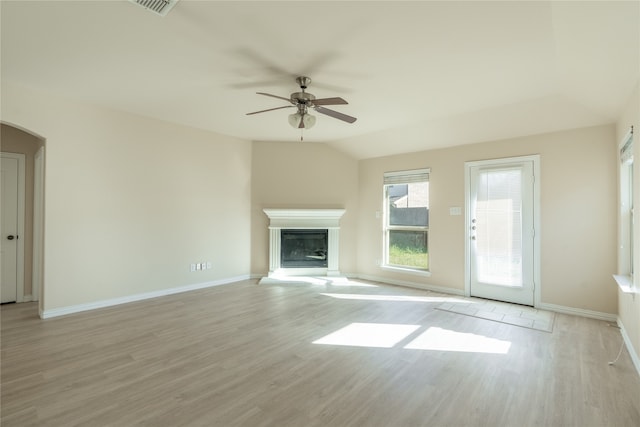 unfurnished living room with light hardwood / wood-style floors, vaulted ceiling, and ceiling fan