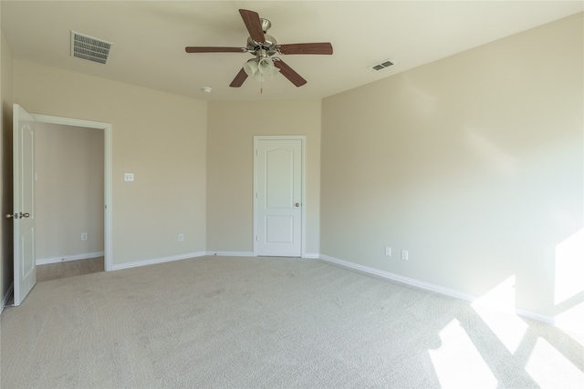 unfurnished room with ceiling fan and light colored carpet