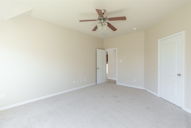 empty room with light carpet, ceiling fan, and vaulted ceiling