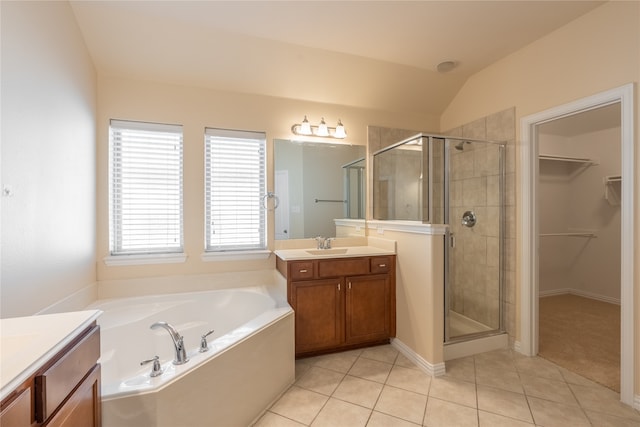 bathroom featuring tile patterned flooring, shower with separate bathtub, vanity, and lofted ceiling