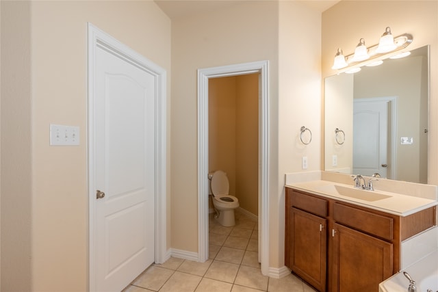 bathroom featuring tile patterned floors, vanity, and toilet