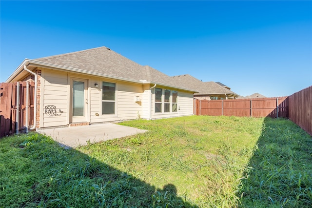 back of property featuring a yard and a patio