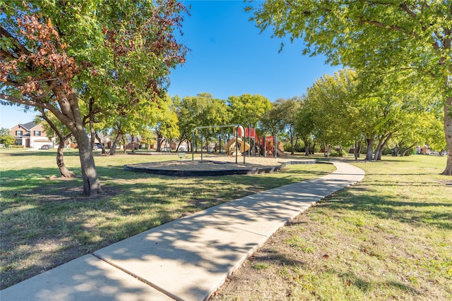 view of property's community featuring a playground and a lawn