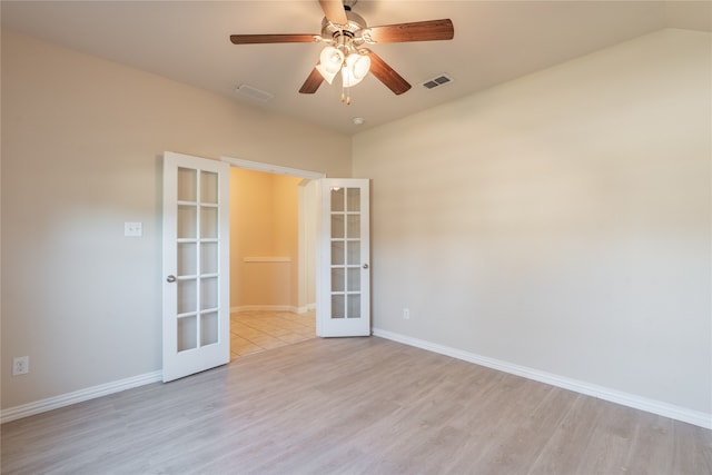 empty room featuring french doors, light hardwood / wood-style flooring, and ceiling fan