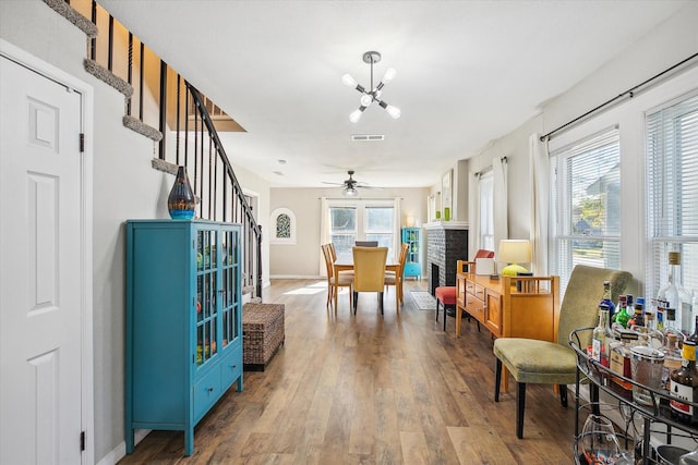 2505 Westbrook Ave, Fort Worth, TX 76111 - living area with a chandelier, wood finished floors, healthy amount of natural light, and stairway