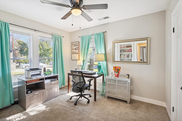 office space with ceiling fan and carpet