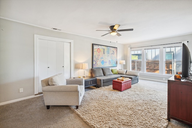 carpeted living room featuring ceiling fan