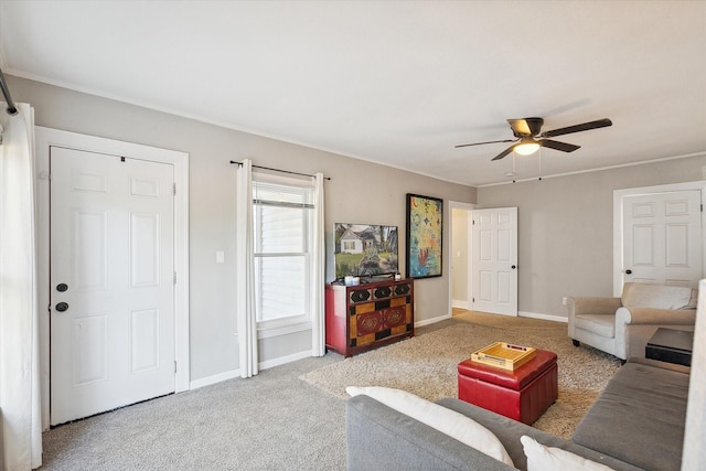 carpeted living room with ceiling fan