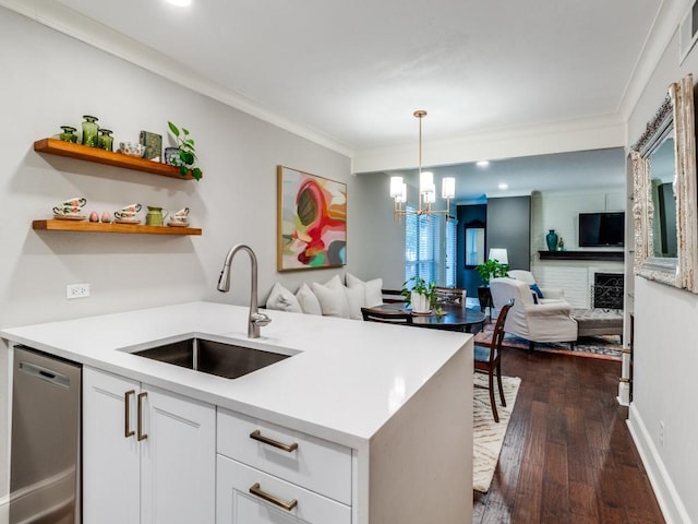 kitchen with stainless steel dishwasher, dark wood-type flooring, sink, a notable chandelier, and white cabinets