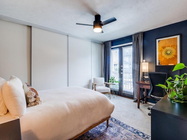 carpeted bedroom featuring access to outside, ceiling fan, and french doors