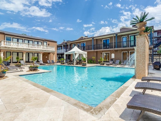 view of pool featuring pool water feature and a patio area