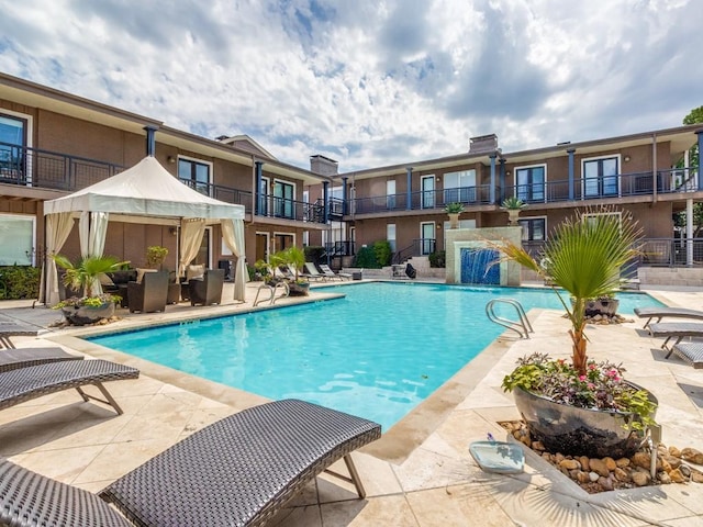 view of pool featuring pool water feature and a patio area