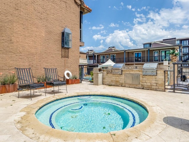 view of swimming pool with an in ground hot tub, area for grilling, a patio area, and a grill