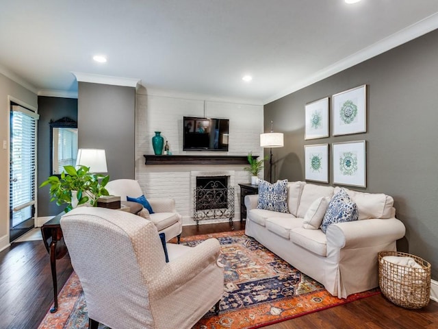 living room with ornamental molding, dark hardwood / wood-style floors, and a brick fireplace