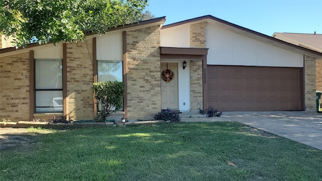 view of front of home with a garage and a front lawn