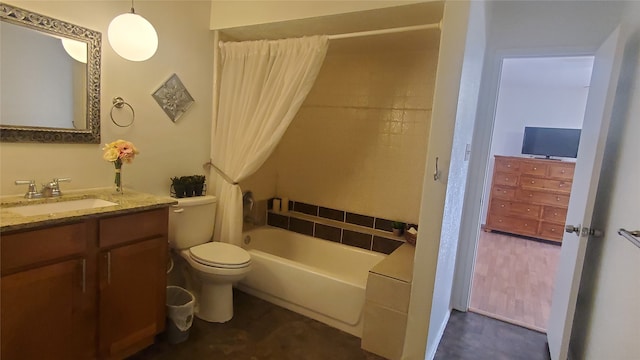 bathroom with a washtub, vanity, and toilet