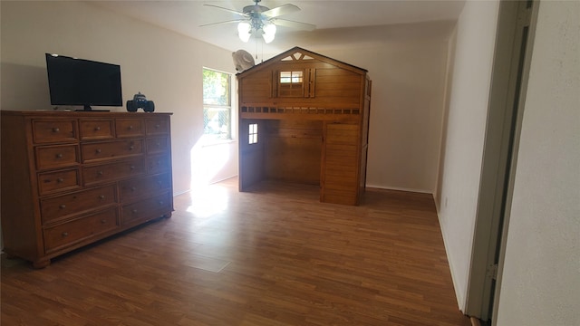 bedroom with ceiling fan and dark hardwood / wood-style floors