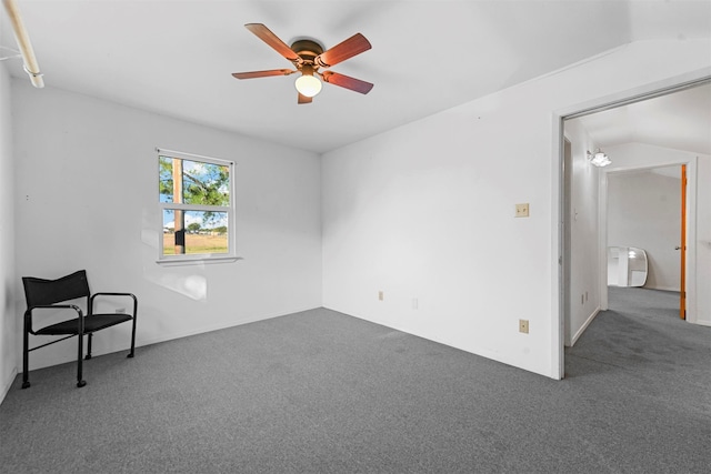 carpeted empty room with ceiling fan and vaulted ceiling